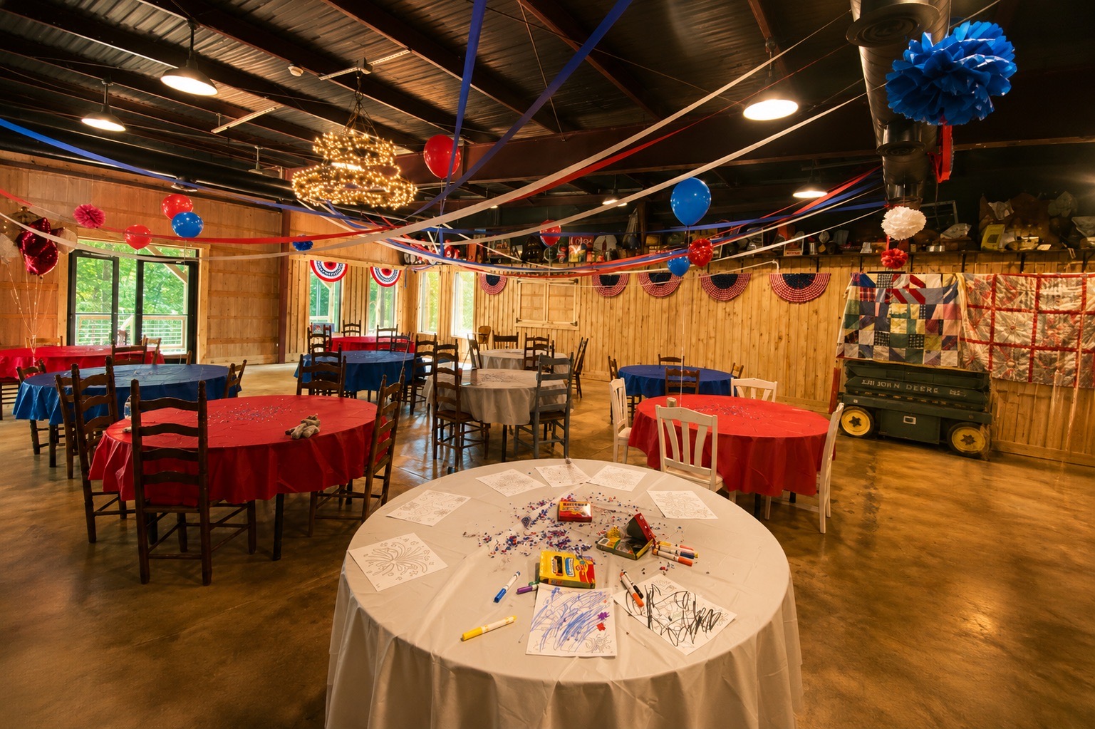 Colorful birthday party tables and decorations inside The Shed at Papa's Creek