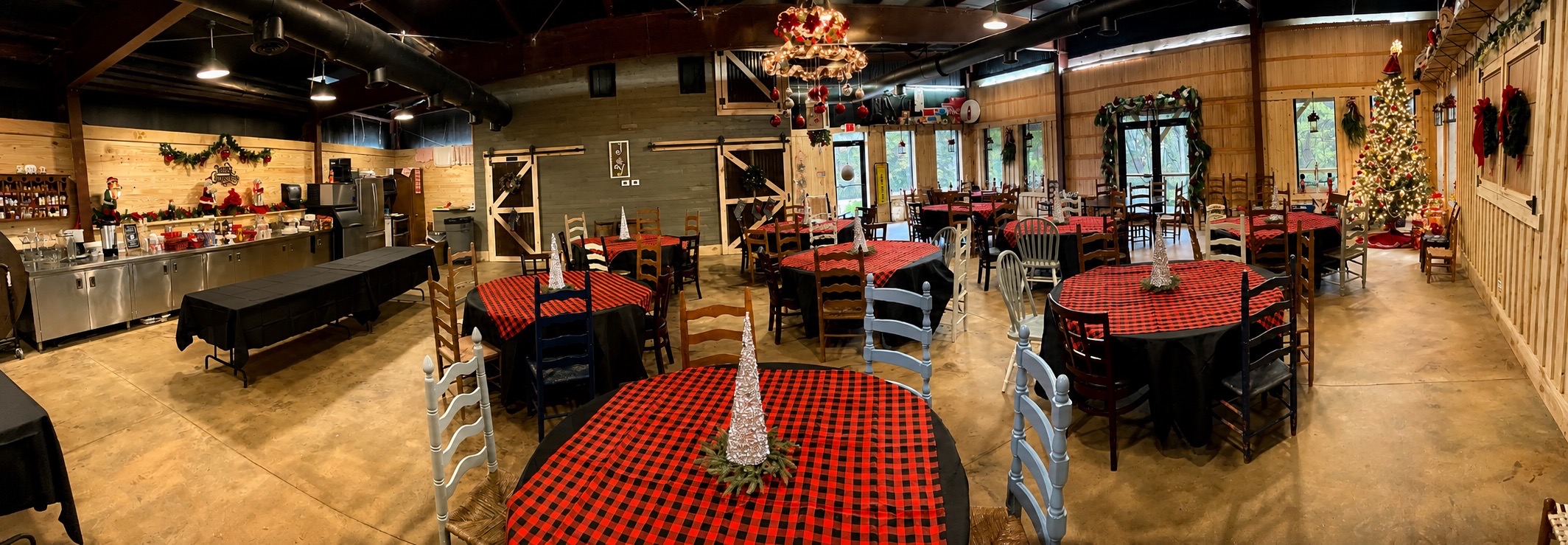 Wide view of tables prepared for a company Christmas party at The Shed