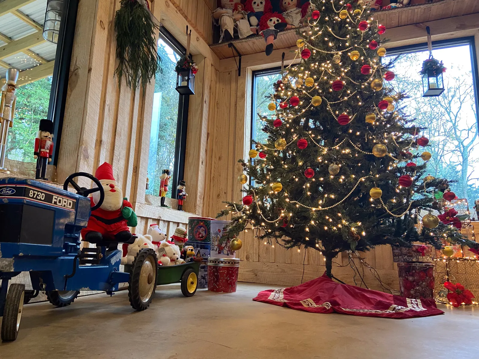 Looking up at the decorated trees, chandelier, and holiday lights inside The Shed at Papa's Creek at Christmas, Lavonia Georgia