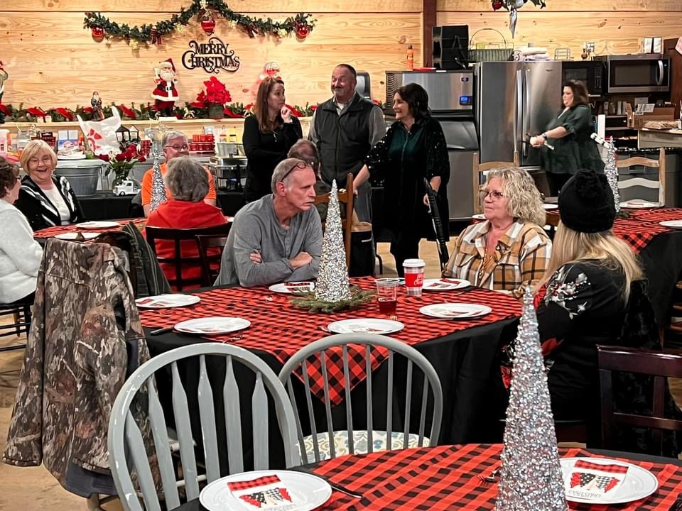 Company guests visiting together during a Christmas gathering at The Shed