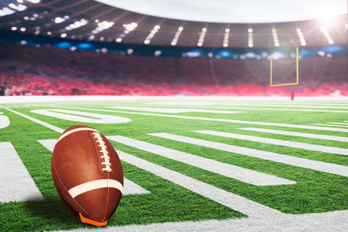 Football on the kicking tee before a crowded stadium