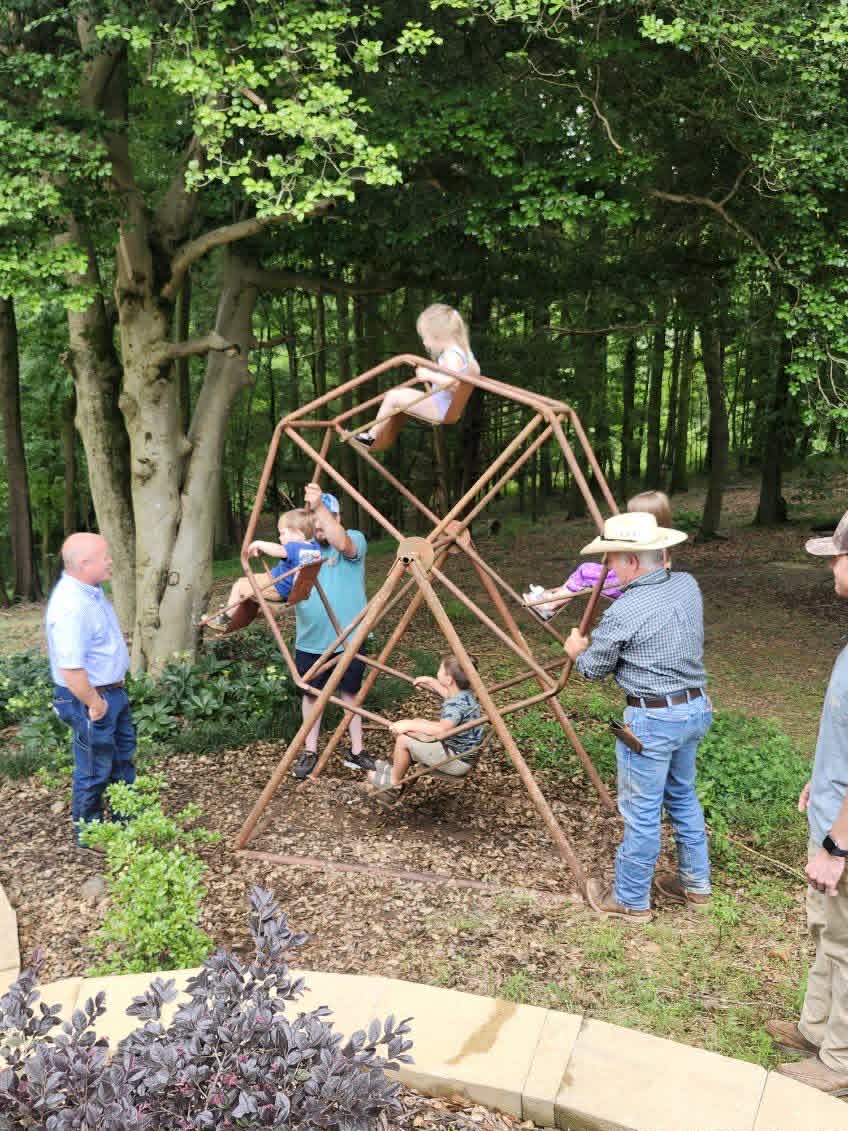 Family and friends enjoying the handmade Ferris wheel on the farm
