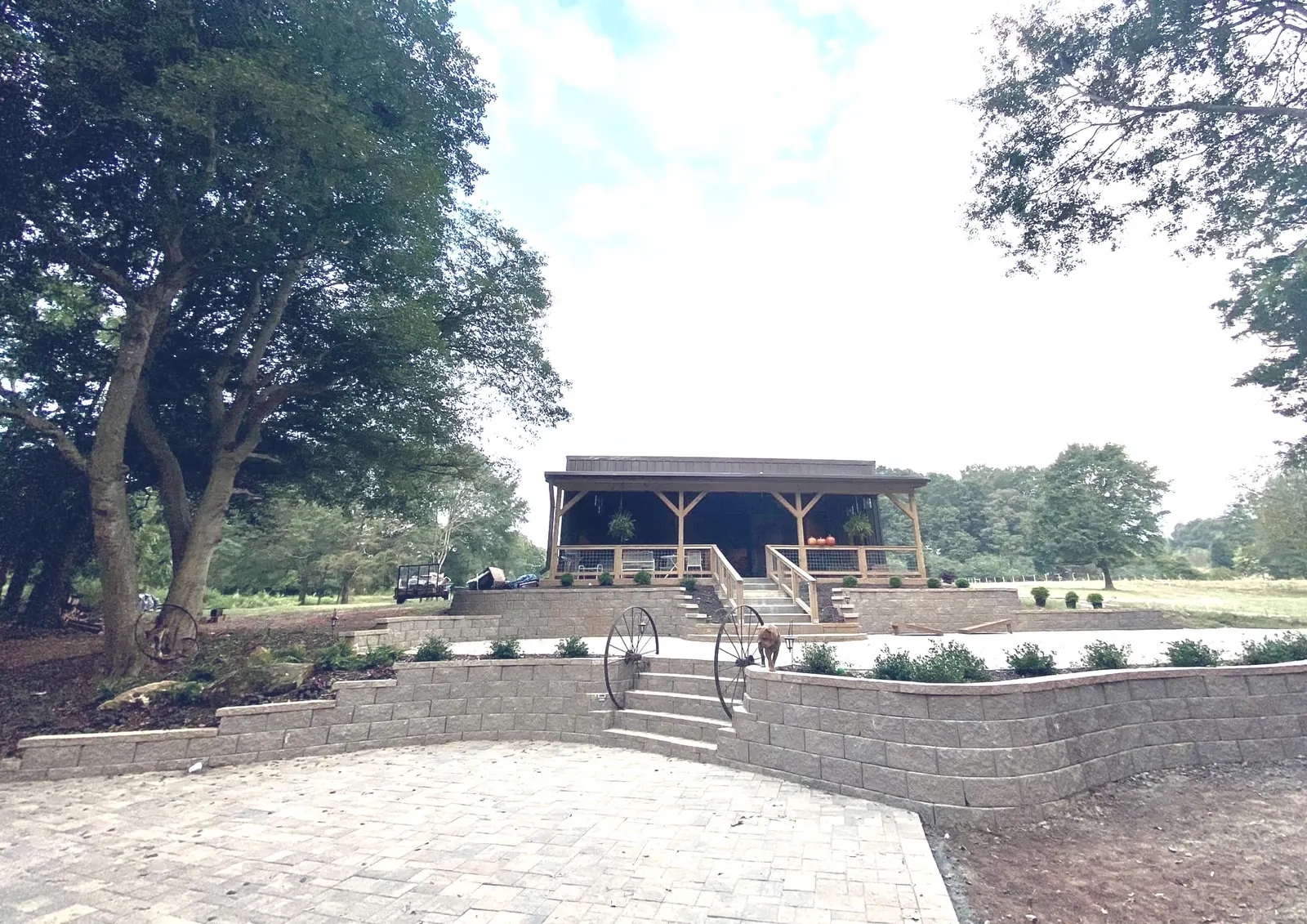Venue exterior – stone terraces and wagon wheel decor at The Shed at Papa's Creek, Lavonia Georgia