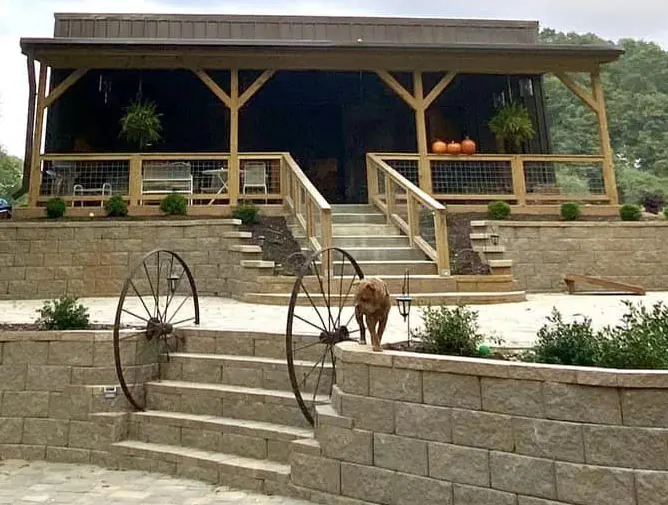 The Shed at Papa's Creek venue exterior – terrace, wagon wheels, and farm dog, Lavonia Georgia