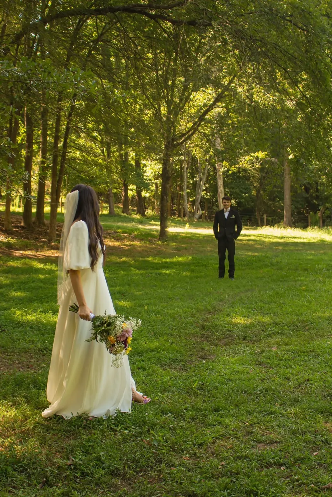 Wedding first look – bride and groom in sunlit field at The Shed at Papa's Creek, Lavonia Georgia