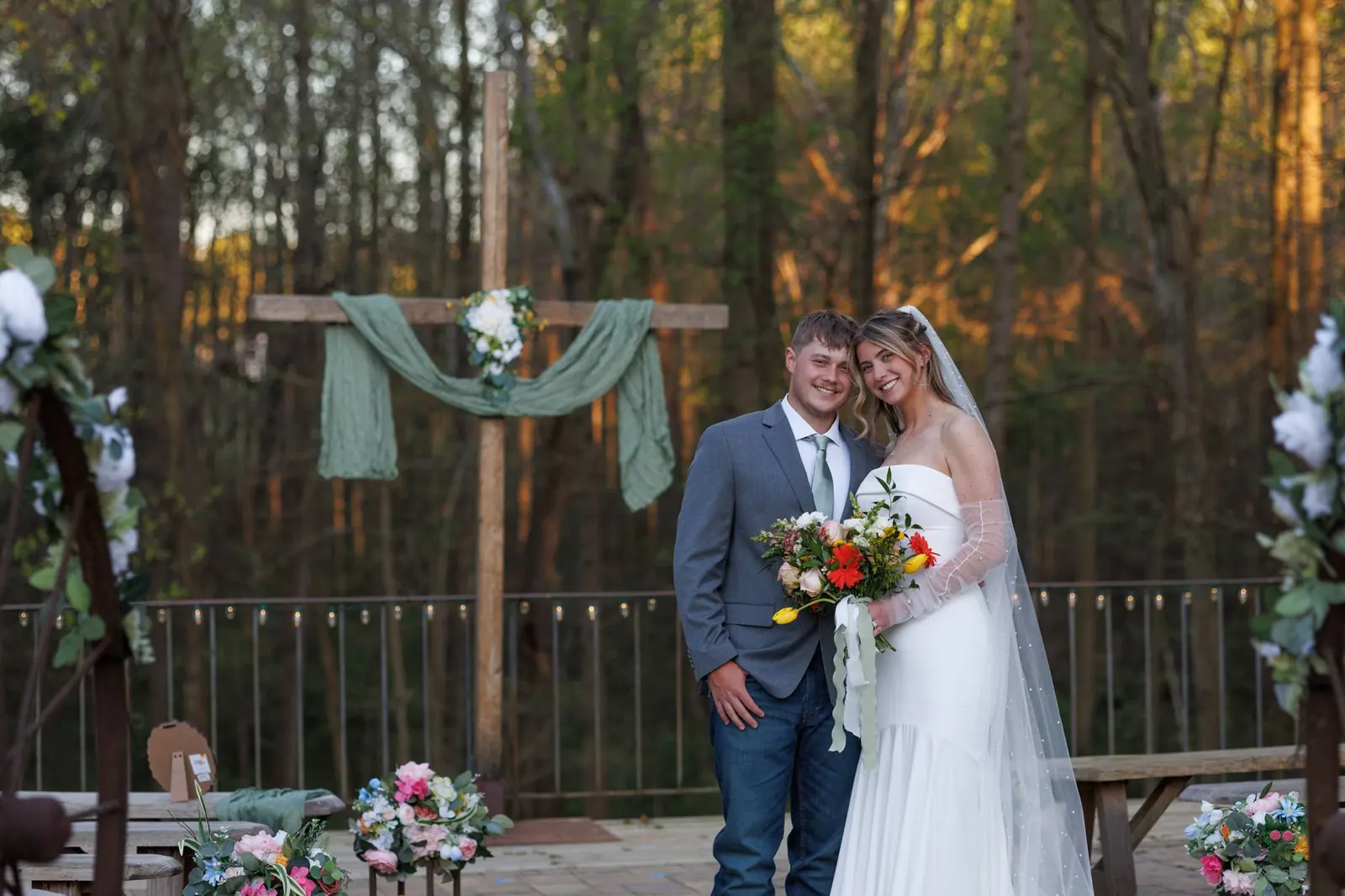 Bride and groom together at the wooden cross altar – ceremony terrace at The Shed at Papa's Creek, Lavonia Georgia, sunset