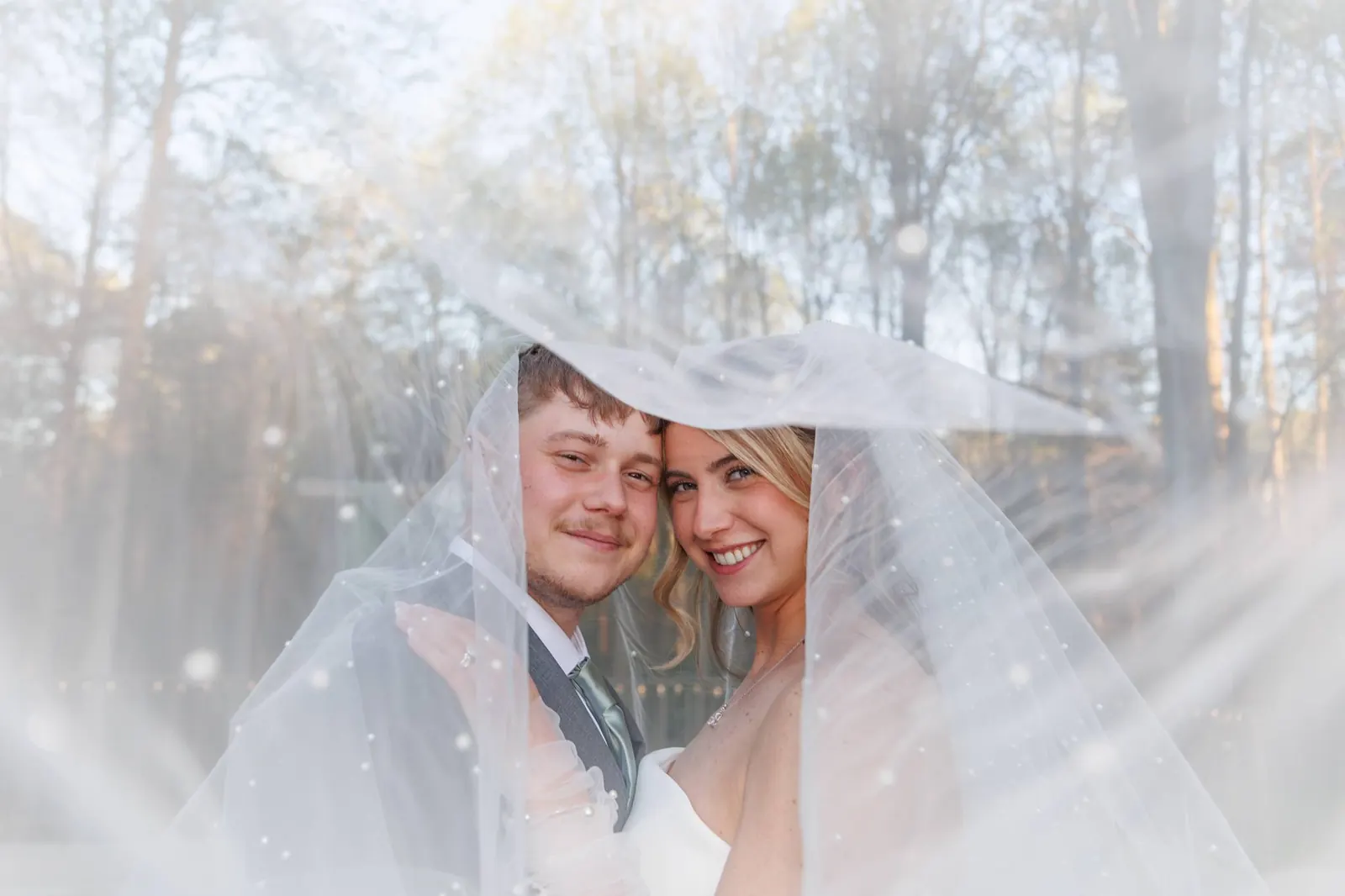 Bride and groom embracing at golden hour on the ceremony terrace at The Shed at Papa's Creek, Lavonia Georgia