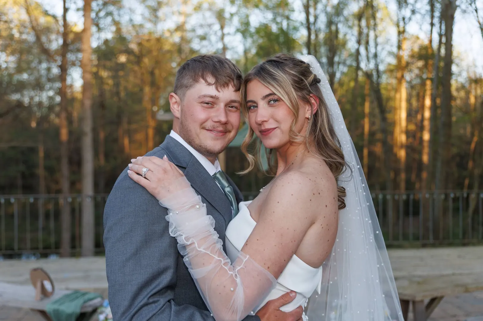 Bride and groom close portrait – ceremony terrace railing and forest at The Shed at Papa's Creek, Lavonia Georgia