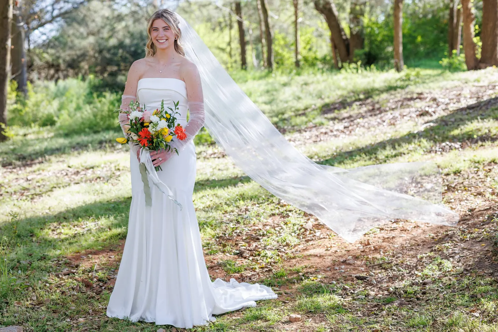 Bride solo portrait in sunlit forest at The Shed at Papa's Creek – veil and colorful bouquet, Lavonia Georgia