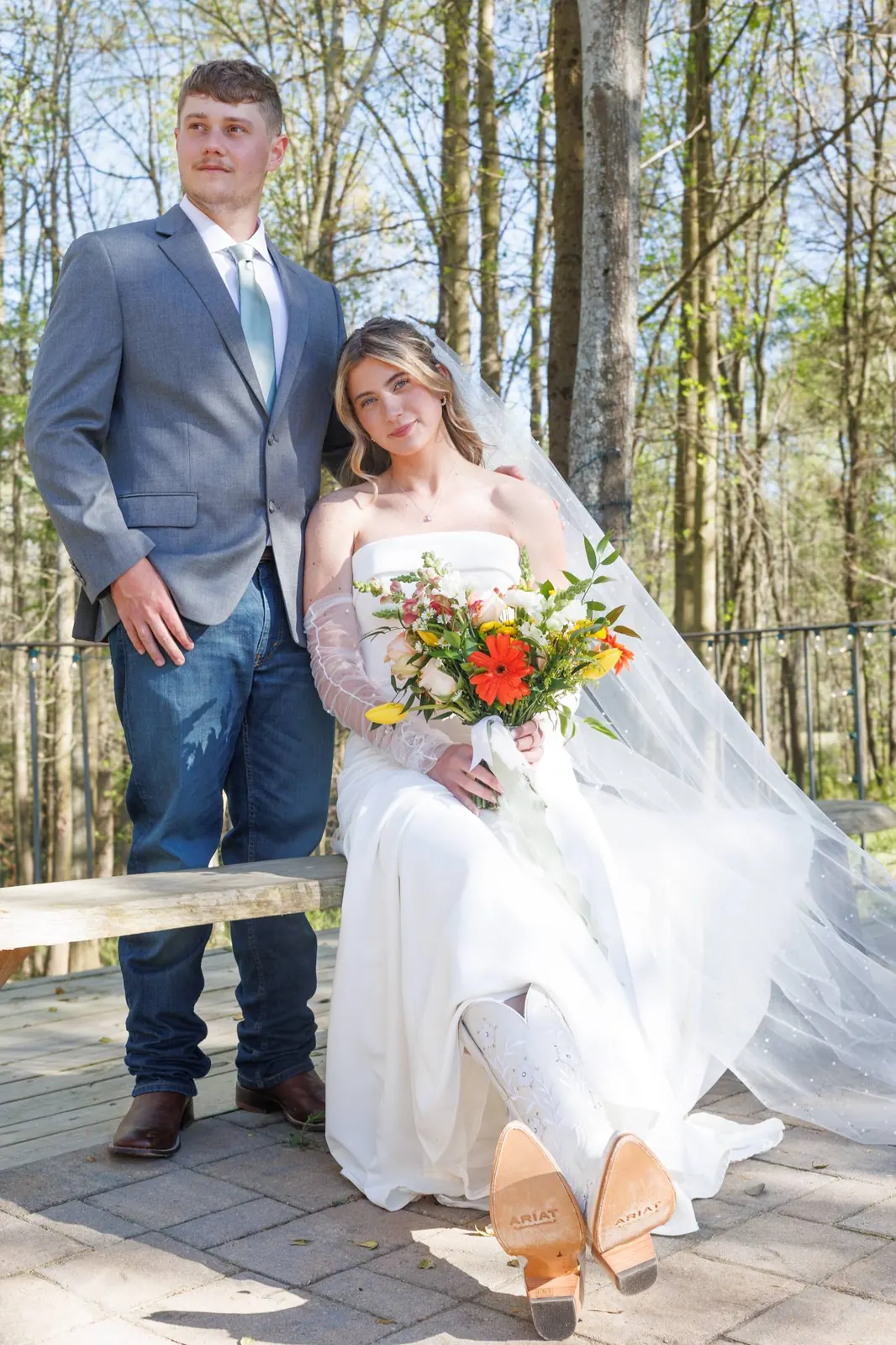 Bride seated and groom standing on the stone terrace at The Shed at Papa's Creek, Lavonia Georgia