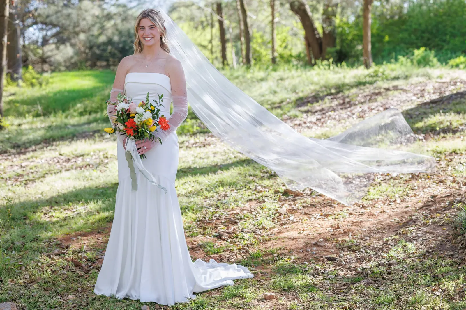 Bride in dappled sunlight on the grounds at The Shed at Papa's Creek – veil caught in the wind, Lavonia Georgia