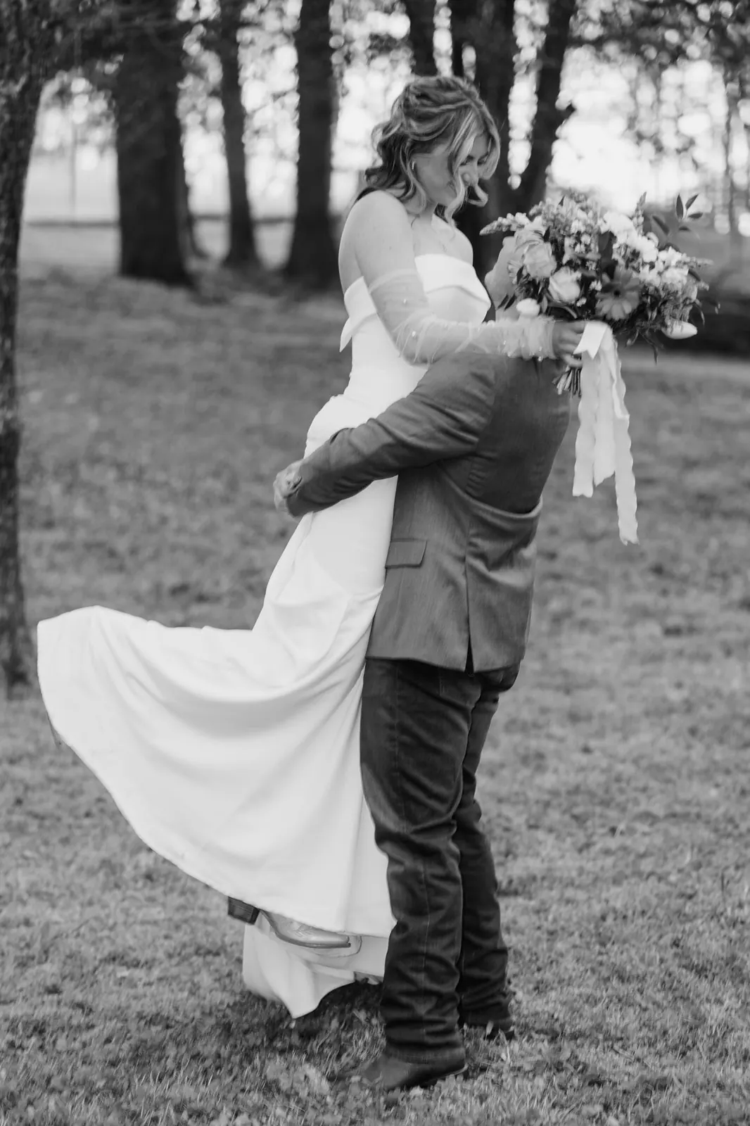 Groom lifting bride in a joyful embrace at The Shed at Papa's Creek – black and white, Lavonia Georgia