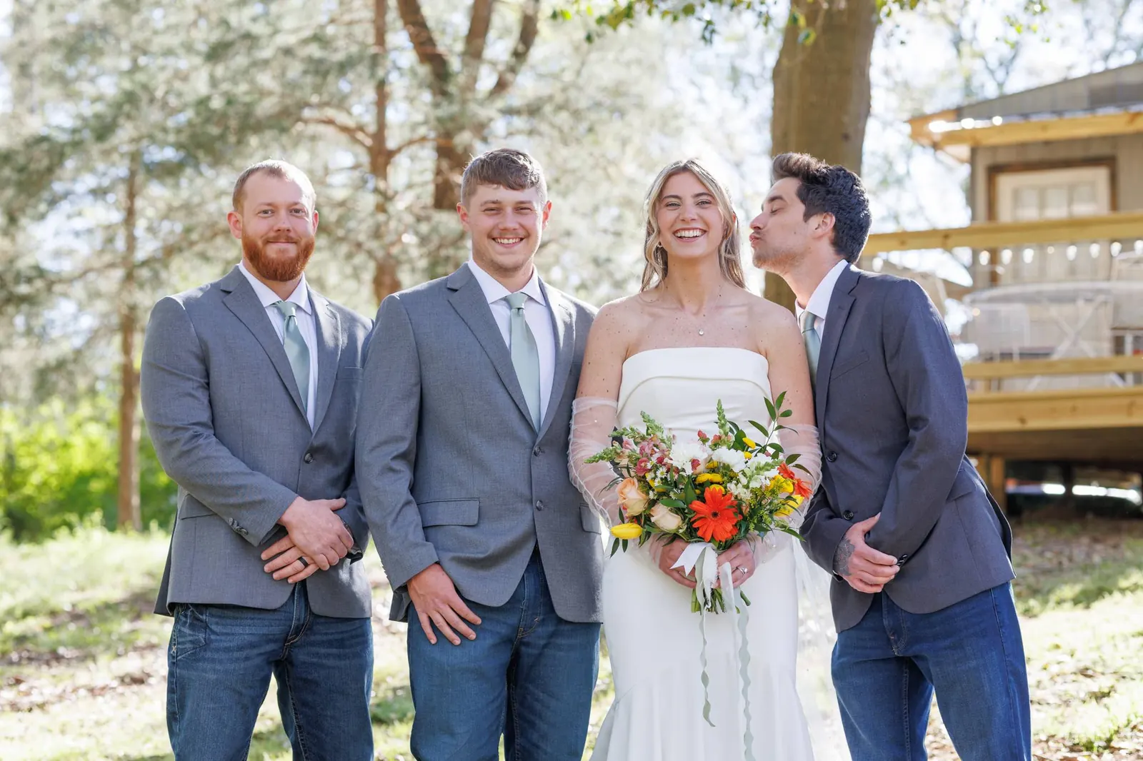 Bride with bridal party outdoors – observation deck visible behind at The Shed at Papa's Creek, Lavonia Georgia