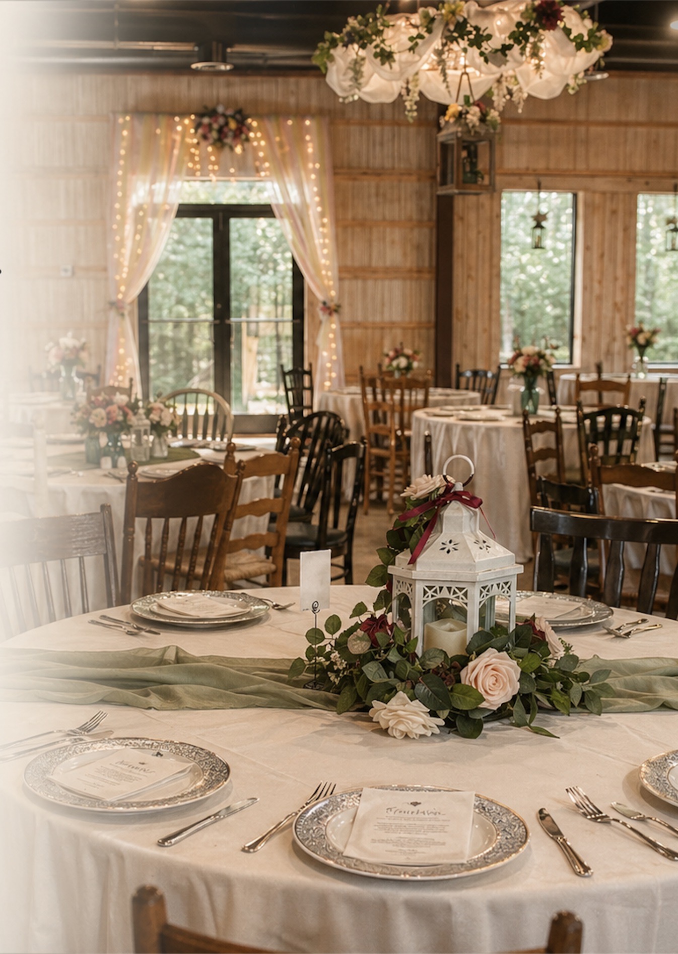 Reception tables set with lanterns inside The Shed beside the open doors