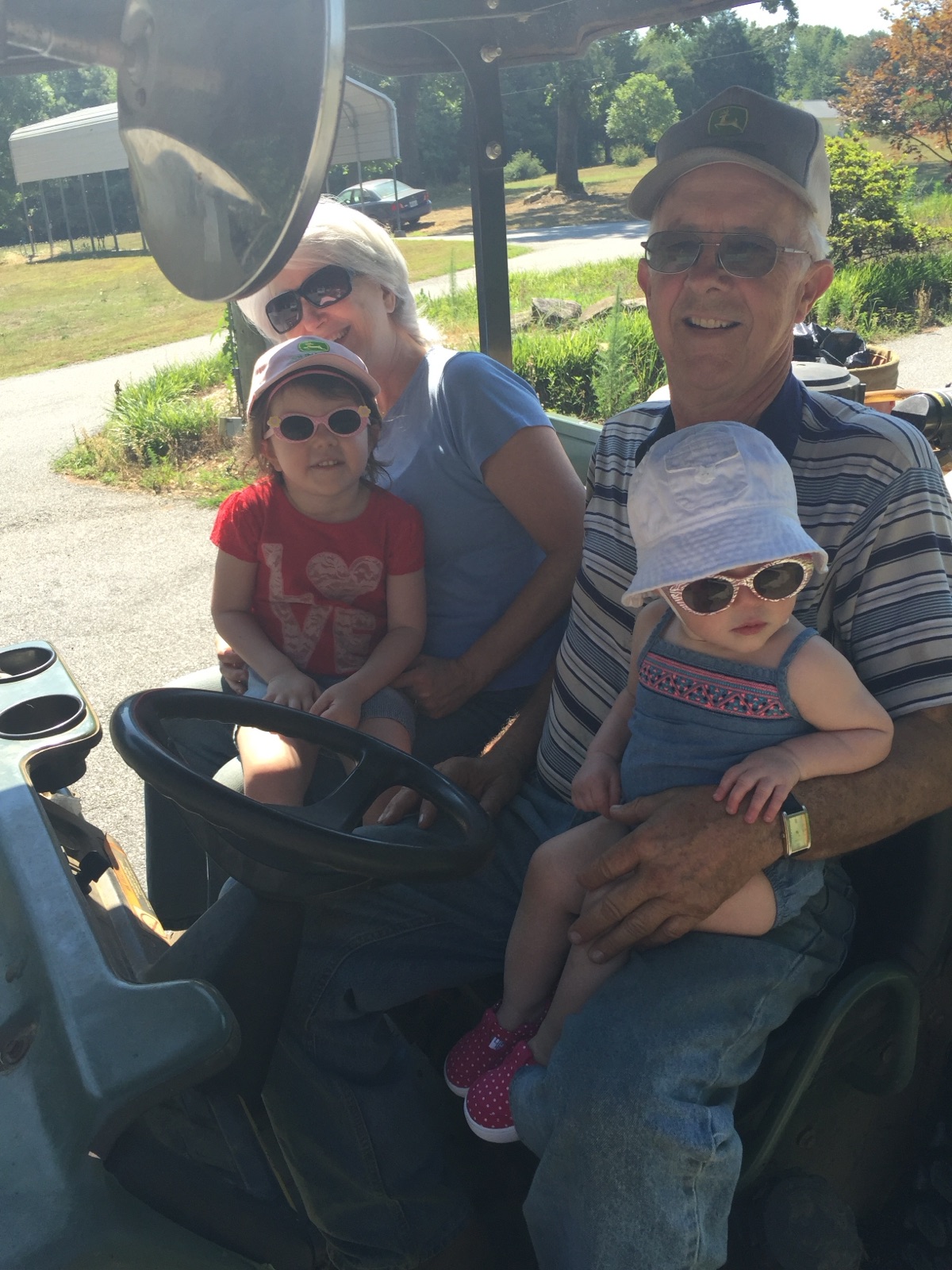 Kenneth and Marie Hendrix riding through the farm with two young girls
