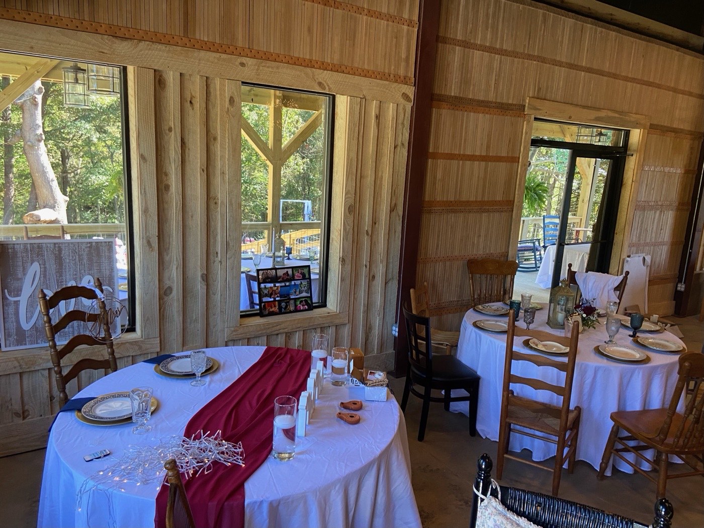 Reception tables being set inside The Shed at Papa's Creek before an event