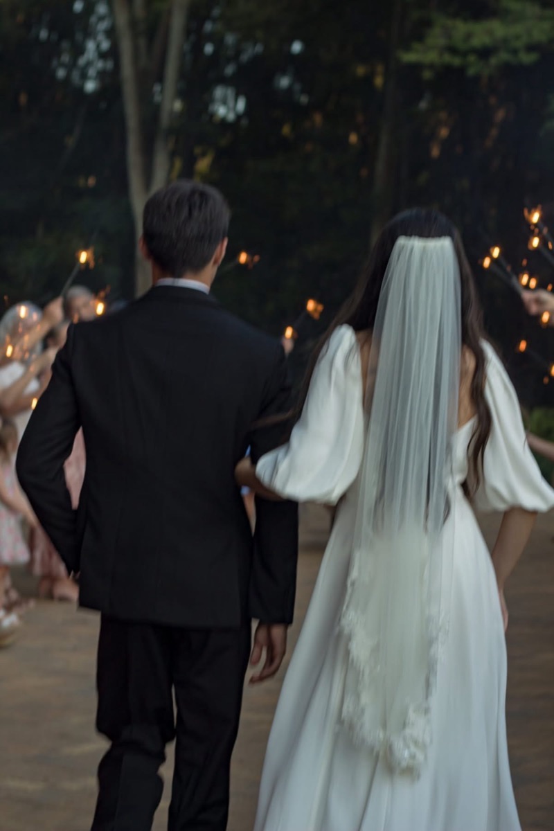 Newlyweds walking through a sparkler sendoff at The Shed at Papa's Creek