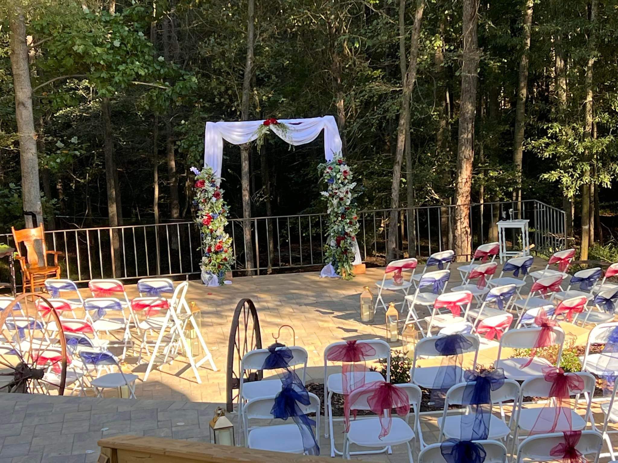 Terrace ceremony seating arranged around a flower-draped arch